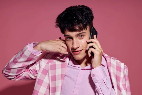 Bastante hombre de moda hablando por teléfono rosa chaqueta posando estudio estilo de vida inalterado — Foto de Stock