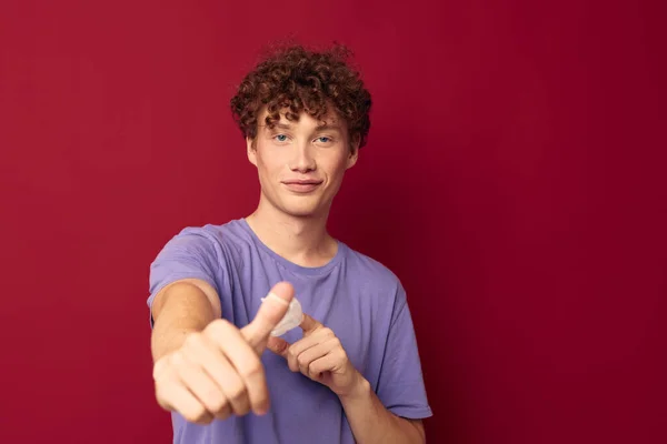 A young man medical mask protection posing red background unaltered — Stock fotografie