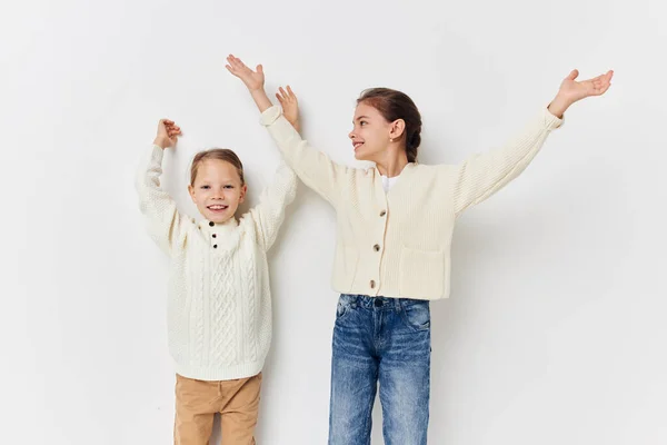 Two little girls girlfriends posing light background — Foto Stock