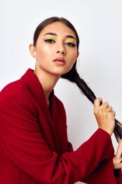 Güzel bir kadın portresi. Parlak makyaj kırmızı ceket. Stüdyo modeli gibi duruyor.