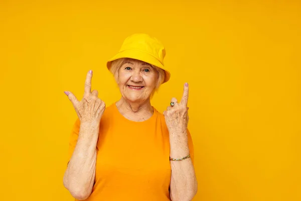 Portrait of an old friendly woman happy lifestyle in a yellow headdress close-up emotions — Stock Photo, Image