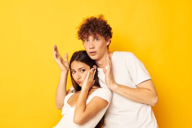 Gençler beyaz tişörtlerle yan yana duruyor. Yaşam tarzını değiştirmeden poz veriyorlar.