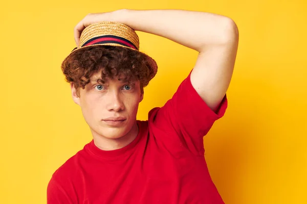 Guy with red curly hair in a red t-shirt with a fashion hat yellow background unaltered — Fotografia de Stock