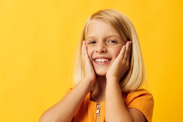 Joyful girl with blond hair gesturing with her hands — Stockfoto