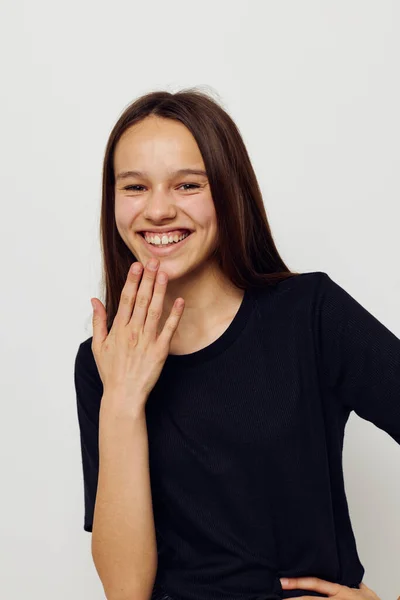 Young beautiful woman in a black t-shirt hand gesture fun isolated background — Stock Photo, Image