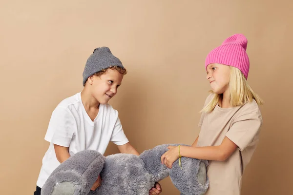 Портрет милых детей в шляпах с плюшевым медведем дружеский изолированный фон — стоковое фото