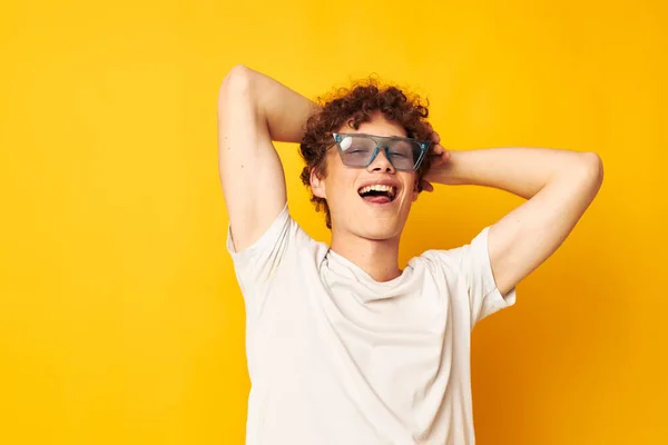 Cute red-haired guy in a white t-shirt blue fashion glasses isolated background unaltered — Stock fotografie