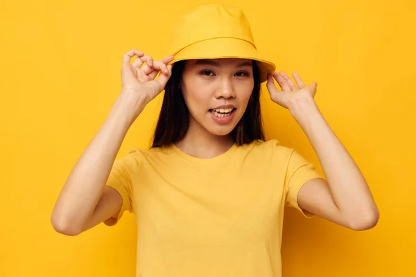 Charming young Asian woman in a yellow t-shirt and hat posing emotions Lifestyle unaltered — Stockfoto
