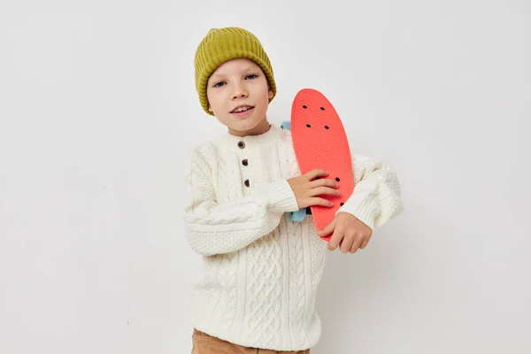 Carino ragazza in cappelli con uno skateboard nelle loro mani luce sfondo — Foto Stock