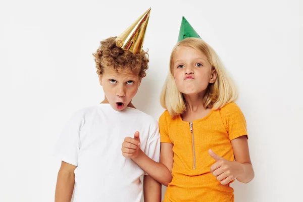Cute stylish kids posing emotions holiday colorful caps isolated background unaltered — Stockfoto