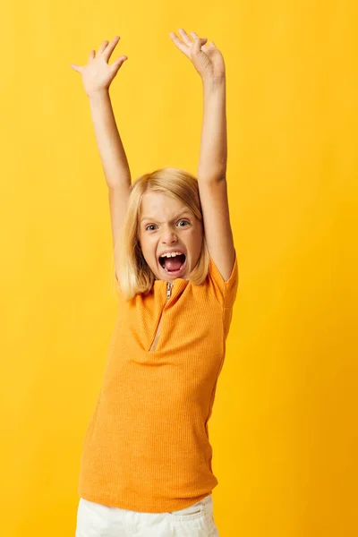 Cute little girl with blond hair based childhood yellow background — Stock fotografie