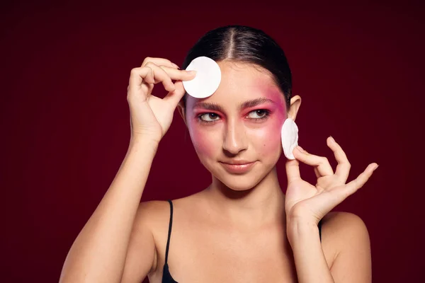 pretty woman pink face makeup posing attractive look skin care pink background unaltered