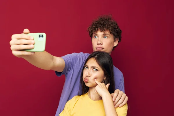 Nice guy and girl take a selfie posing hug Youth style — Stock Photo, Image
