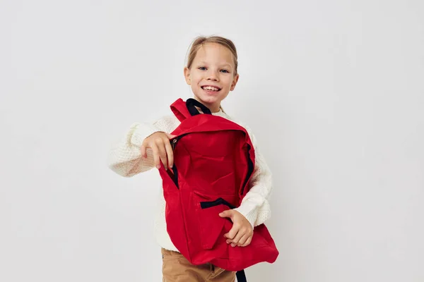 Little girl school red backpack posing isolated background — Stock fotografie