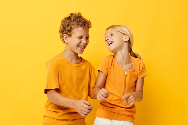 Cute stylish kids in yellow t-shirts standing side by side childhood emotions isolated background unaltered — 图库照片