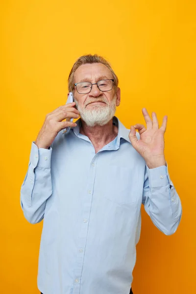 Retrato de hombre mayor feliz barba gris con gafas hablando en el teléfono vista recortada —  Fotos de Stock