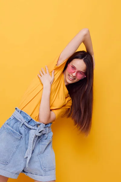 Young beautiful woman in a yellow t-shirt emotions summer style isolated background — Stockfoto