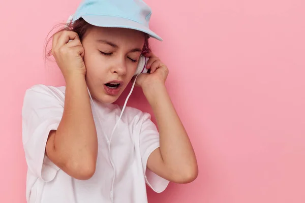 Portrait of happy smiling child girl headphones in a white t-shirt and a cap Lifestyle unaltered — Φωτογραφία Αρχείου