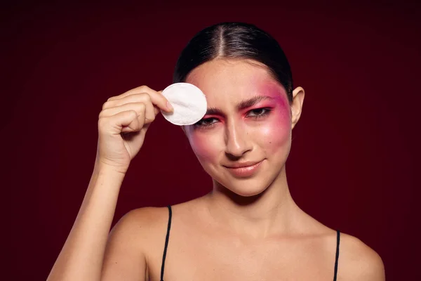Sexy brunette woman pink face makeup posing attractive look skin care cropped view unaltered