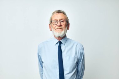 İş elbisesi içinde gri sakallı yaşlı adam.