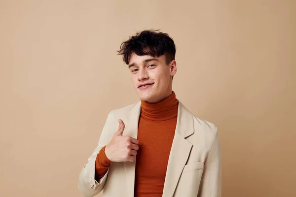 Photo young boyfriend posing with a phone in his hands in a jacket elegant style model studio — Stock fotografie