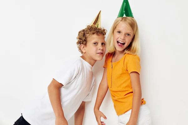 Cute stylish kids posing emotions holiday colorful caps isolated background unaltered — Stock fotografie