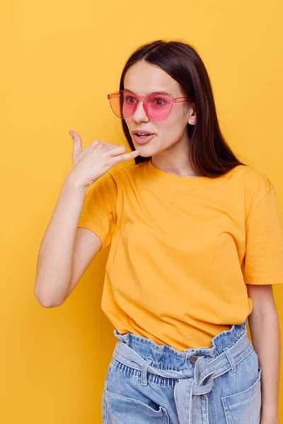 Beautiful girl fashion in yellow t-shirt denim shorts isolated background — Stock Photo, Image