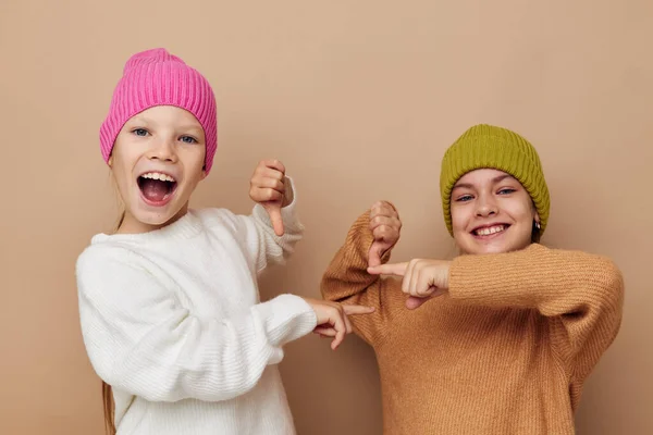 Two funny little girls in colorful hats — Stock Photo, Image