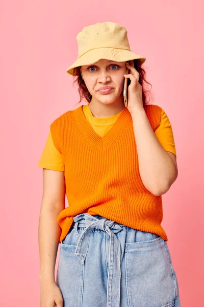 Portrait of a young woman communicates on the phone in yellow hat fashion cropped view unaltered — Fotografia de Stock