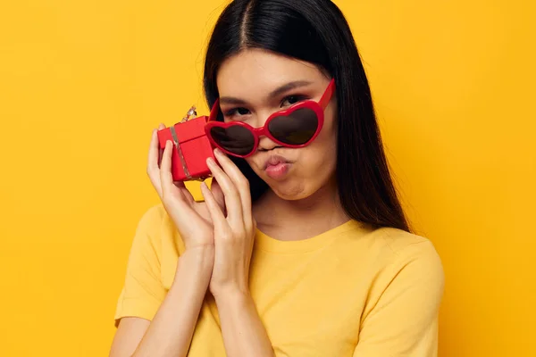 Woman with Asian appearance with gift boxes in hands fun posing studio model unaltered — Stockfoto