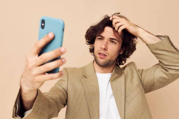 Homem de terno posando emoções olhando para o telefone isolado fundo — Fotografia de Stock