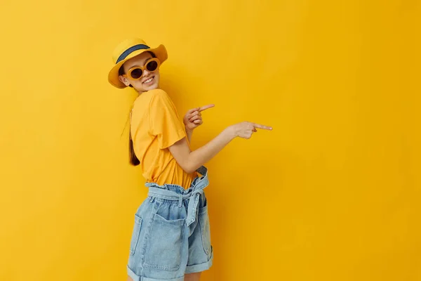 Young woman in a yellow hat Youth style casual wear in sunglasses isolated background — Stockfoto