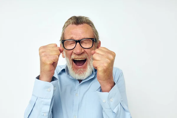 Elderly man in shirt and glasses posing emotions isolated background — Stock fotografie
