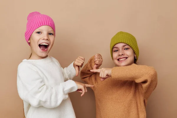 Portrait of two cheerful girls in hats posing friendship — Stock Photo, Image