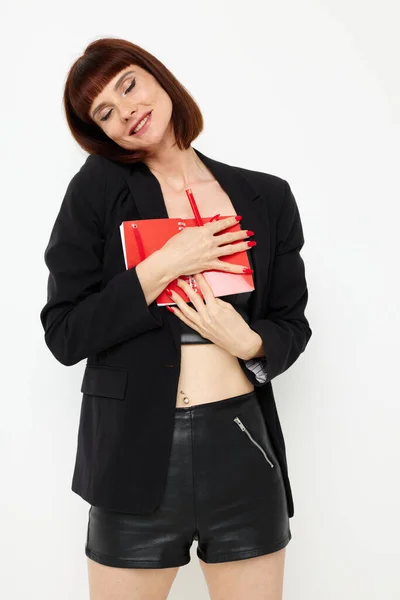 Porträtt av en kvinna röd anteckningsblock och penna poserar isolerad bakgrund — Stockfoto