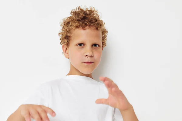 Ragazzo emotivo con i capelli ricci in una t-shirt bianca da vicino — Foto Stock