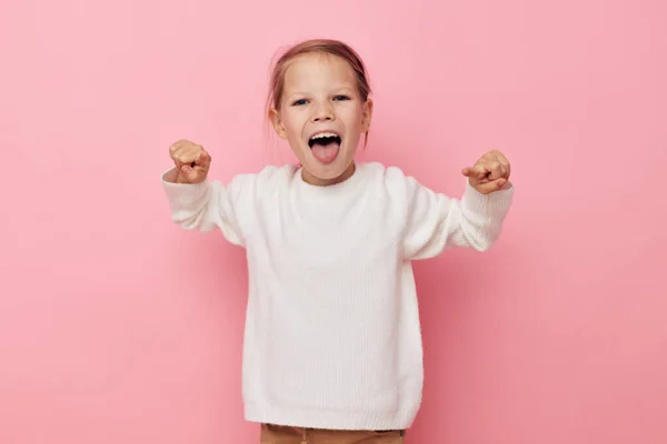 Portrait of happy smiling child girl white sweater posing fun Lifestyle unaltered — Fotografia de Stock