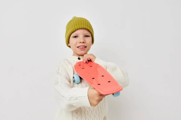 Portrait of happy smiling child girl posing skateboard entertainment light background — Stock fotografie