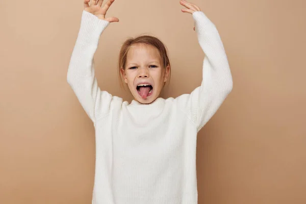Portrait of happy smiling child girl joy posing emotions fashion beige background — Stockfoto