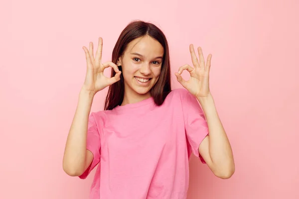 Optimistic young woman in a pink t-shirt casual clothes isolated background — Stockfoto