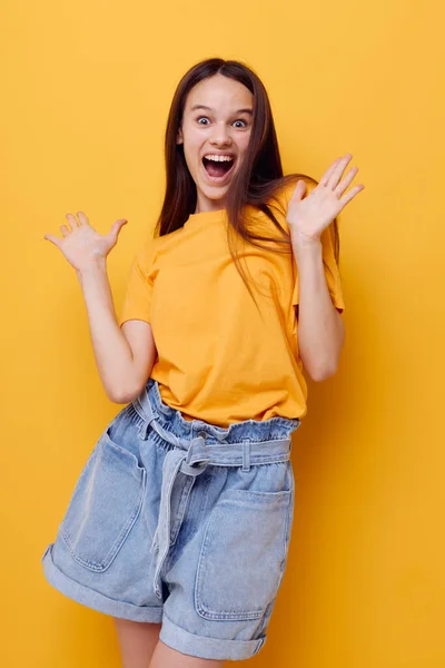Young beautiful woman in a yellow t-shirt emotions summer style isolated background — 图库照片