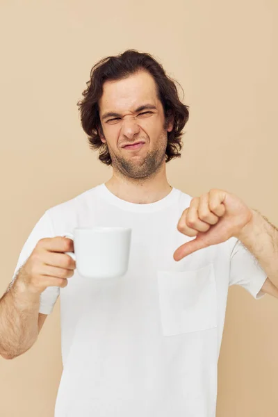 Attractive man with a white mug in his hands emotions posing isolated background — Fotografia de Stock