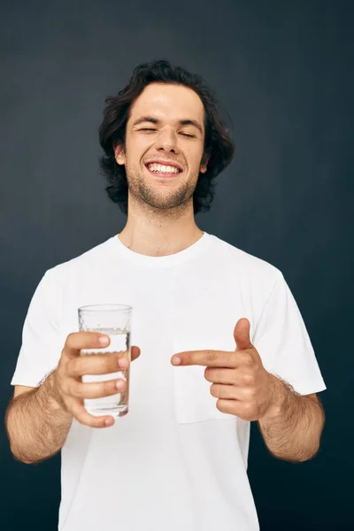 Красивий чоловік у білій футболці склянці води Стиль життя незмінний — стокове фото