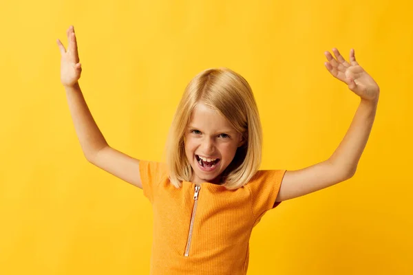 Cheerful little girl hand gesture and fun yellow background — Fotografia de Stock