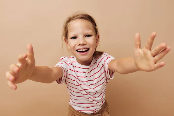 Cheerful girl in a striped T-shirt gestures with her hands — Stock Photo, Image