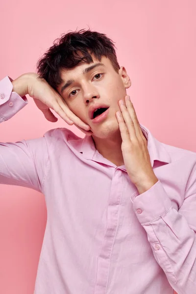 Handsome guy gestures with hands emotions hairstyle fashion pink background unaltered — 图库照片