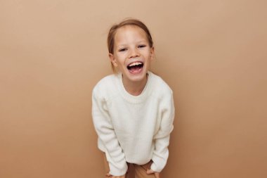 Sevimli kız neşesi Duyguları poz verme moda bej arka plan