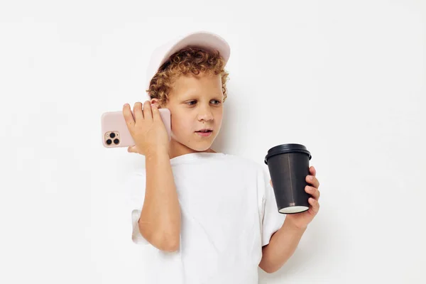 Lindo chico hablando por teléfono con un negro vidrio aislado fondo inalterado — Foto de Stock