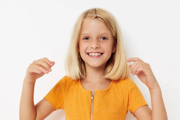 Маленькая девочка с светлыми волосами улыбается, позируя весело — стоковое фото