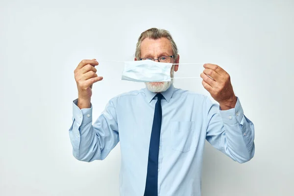 Portrait elderly man in shirt with tie medical mask safety light background — Stock Photo, Image